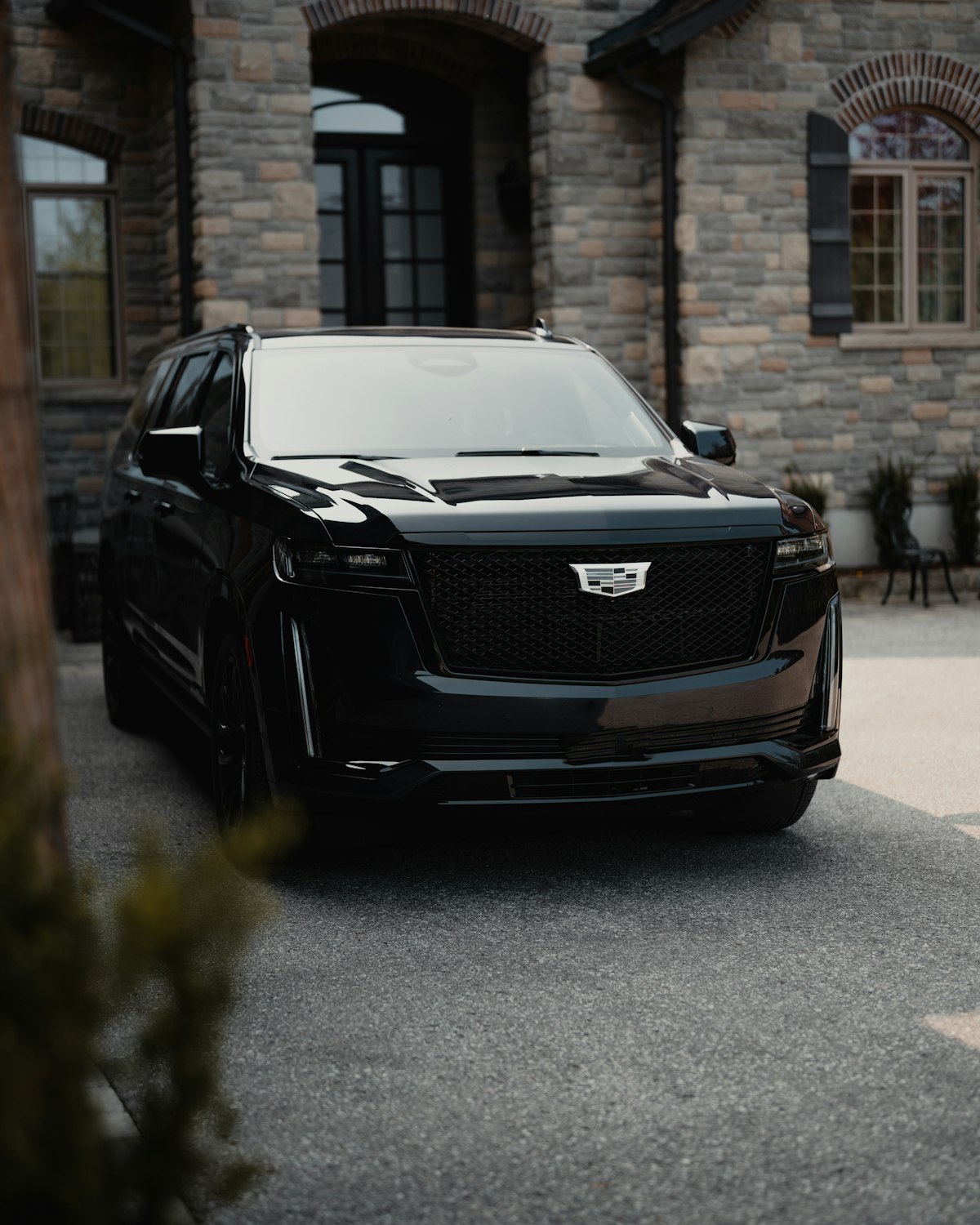 Black SUV in front of a stone building